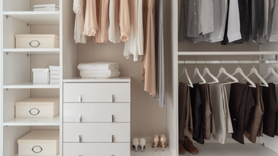 An organized white closet with a variety of clothing items.